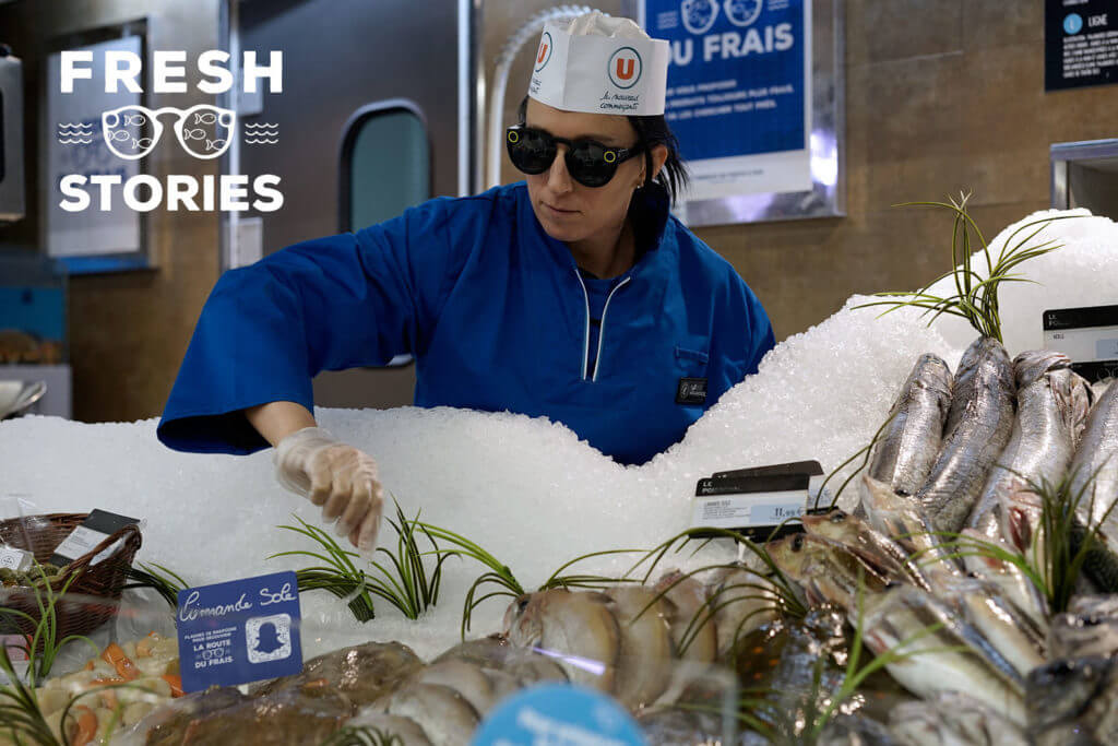 Image of a person next to fresh fish.