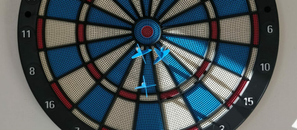 dart board with three darts.